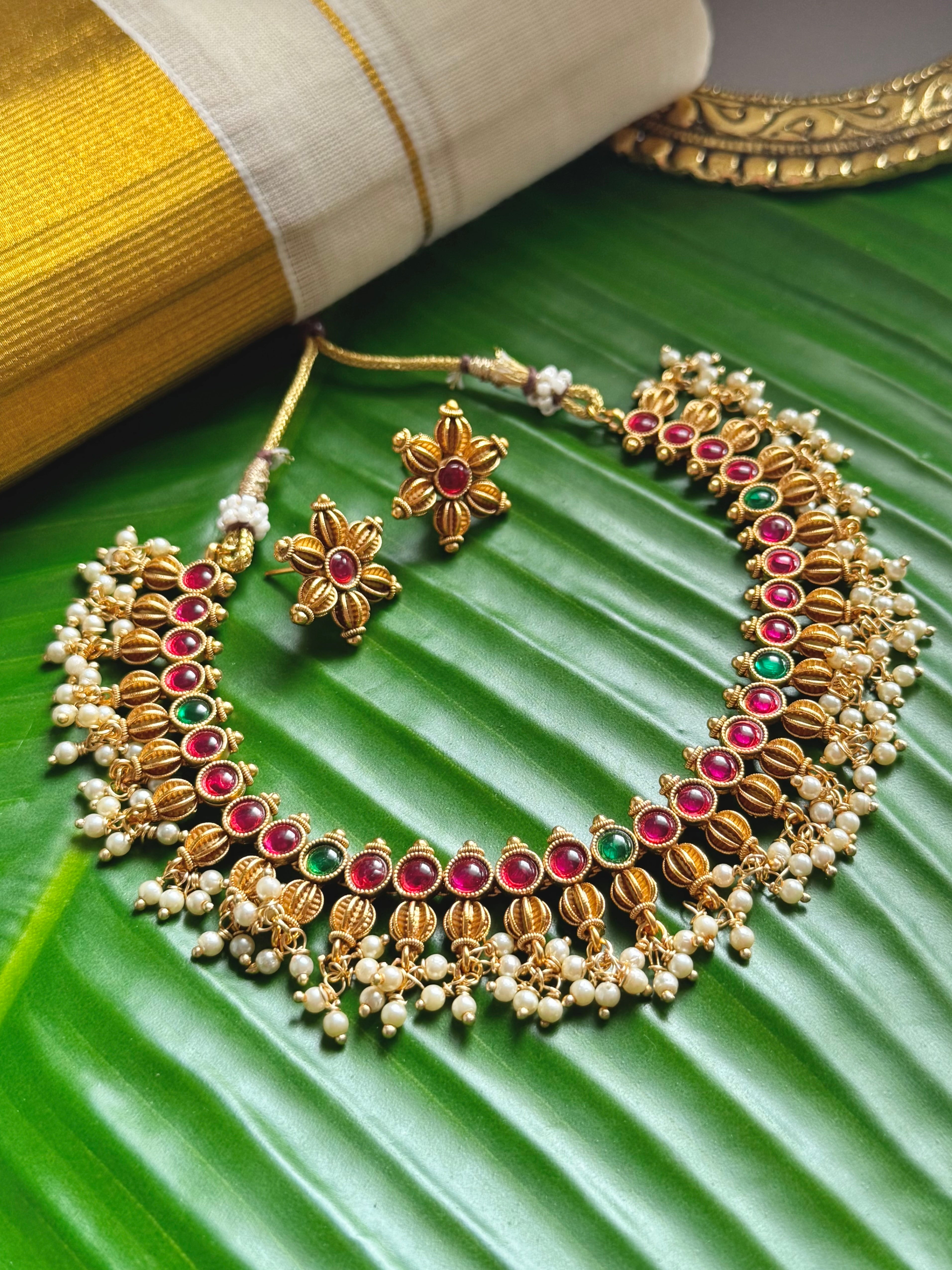 Necklace set with red and green accent stones